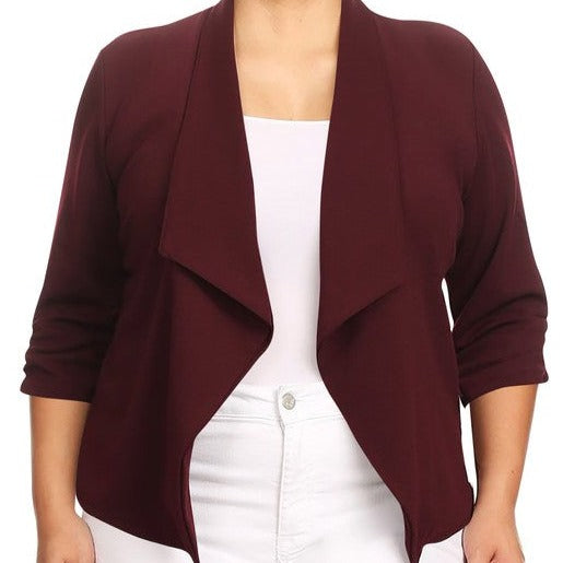 Our Plus Size Solid Waist Length Blazer featuring a relaxed fit and open front, designed in a waist-length style, complete with a draped neckline and rolled-up sleeves with ruched detailing.