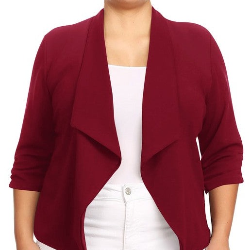 Our Plus Size Solid Waist Length Blazer featuring a relaxed fit and open front, designed in a waist-length style, complete with a draped neckline and rolled-up sleeves with ruched detailing.