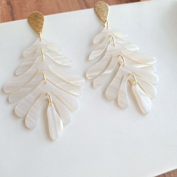 These resort-wear-inspired earrings feature a palm leaf design with gold accents, making them the perfect accessory for a touch of an elegant tropical look. 18k gold-plated hypoallergenic stainless steel posts with a laser cut design detail Durable plant-based acrylic.