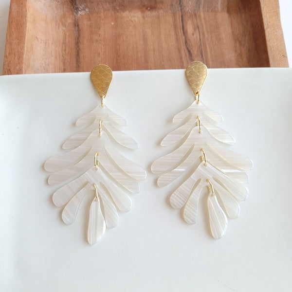 These resort-wear-inspired earrings feature a palm leaf design with gold accents, making them the perfect accessory for a touch of an elegant tropical look. 18k gold-plated hypoallergenic stainless steel posts with a laser cut design detail Durable plant-based acrylic.