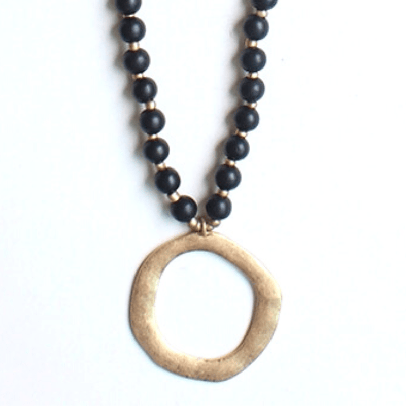 This beautiful black wood bead and gold circle necklace is a must-have for fall season. The length can be adjusted to just the right fit, making it perfect for any occasion.