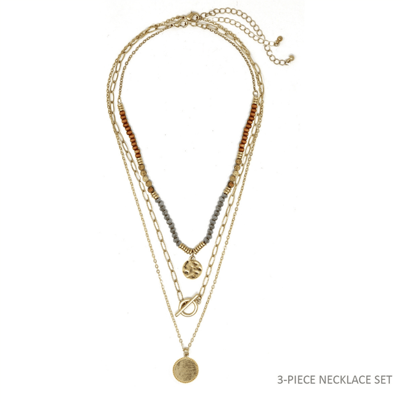 This triple-layered necklace is crafted using natural stones and gold accents. The brown color and simplicity of the design make this a classic piece that can be worn with any outfit or on any occasion.