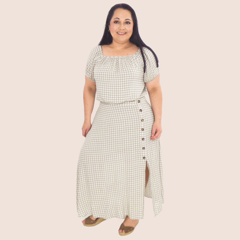 This plus-size, super cute skirt is the perfect dress up or down midi length. Featuring a gingham pattern, back elastic waist and buttons up the side slit