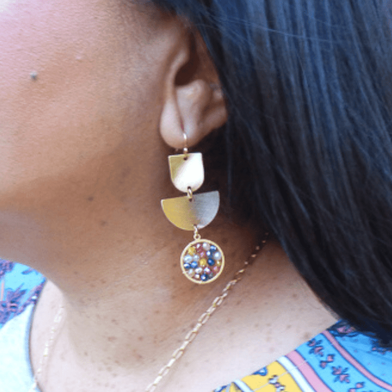 This stylish earring is designed with a gold geometric shape and accented with a variety of colorful crystals. 