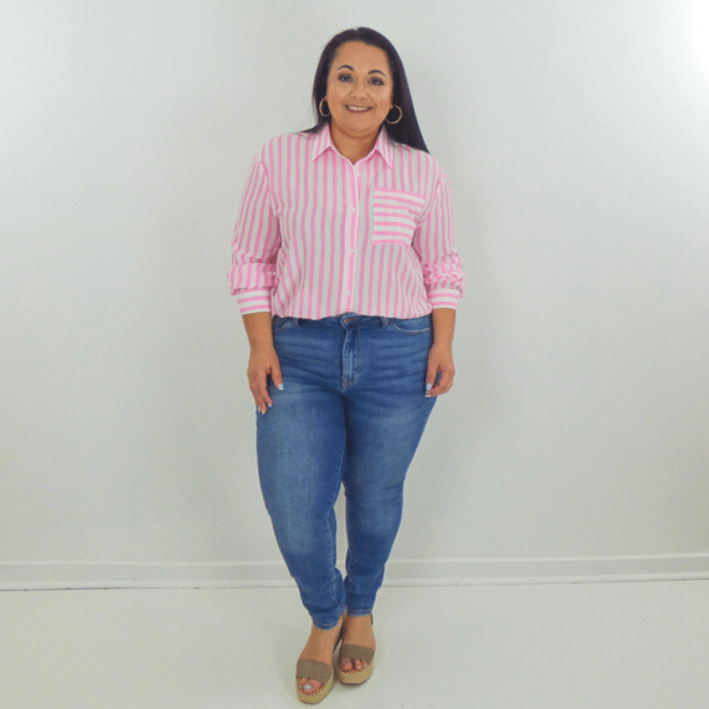 Look cute and casual in this lightweight striped button-up top. The Newport features a lightweight material, a pink striped pattern, functional buttons, a collared neckline, a chest pocket, and a high low round hemline.