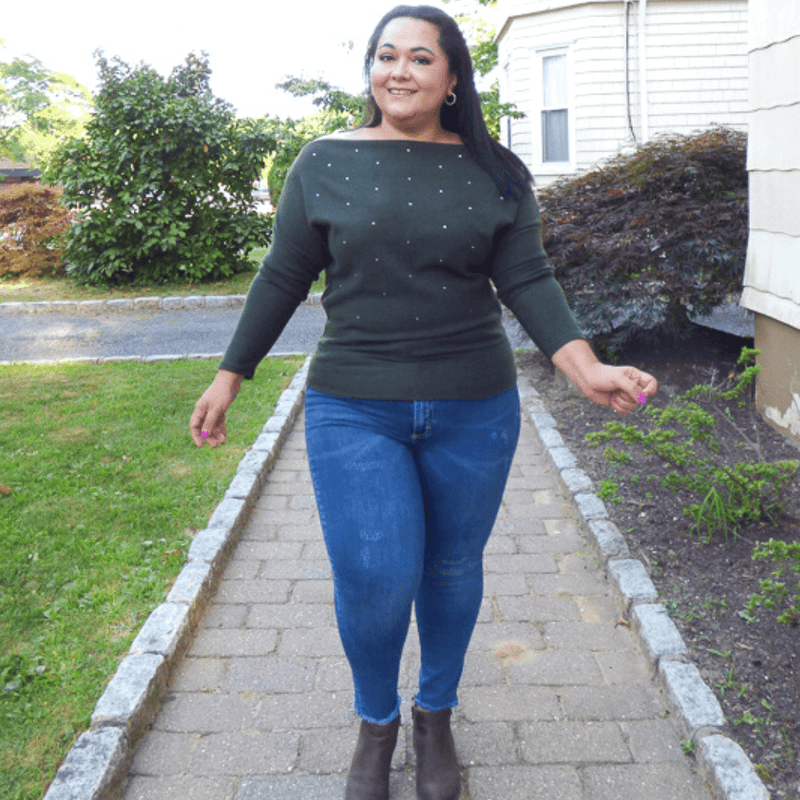 The Open Shoulder Embellished Plus Size Sweater is perfect for cooler weather. It features a silver pearl embellishment and a unique open shoulder design.