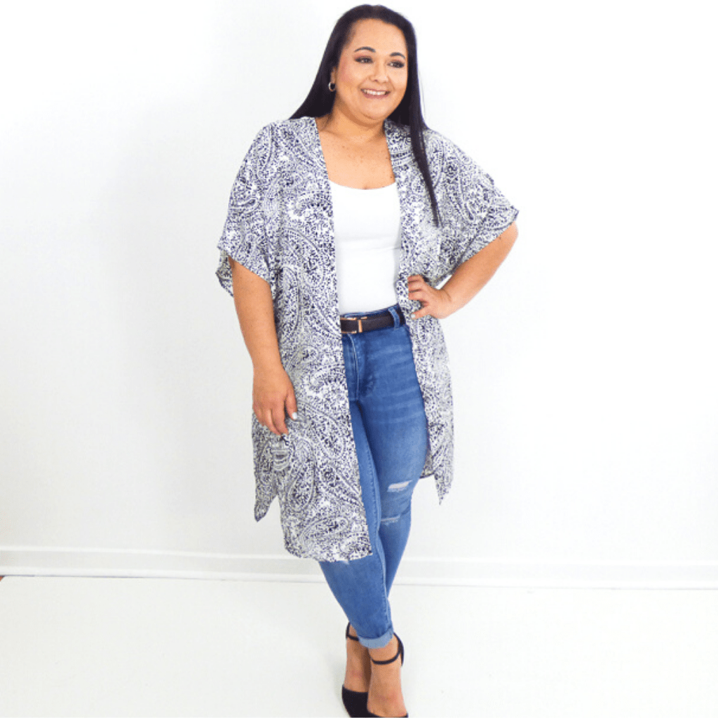 A fun kimono with a beautiful paisley print and an open front. This kimono lands on the knee and has half sleeves, making it perfect for layering over dress tanks or even swimsuits.