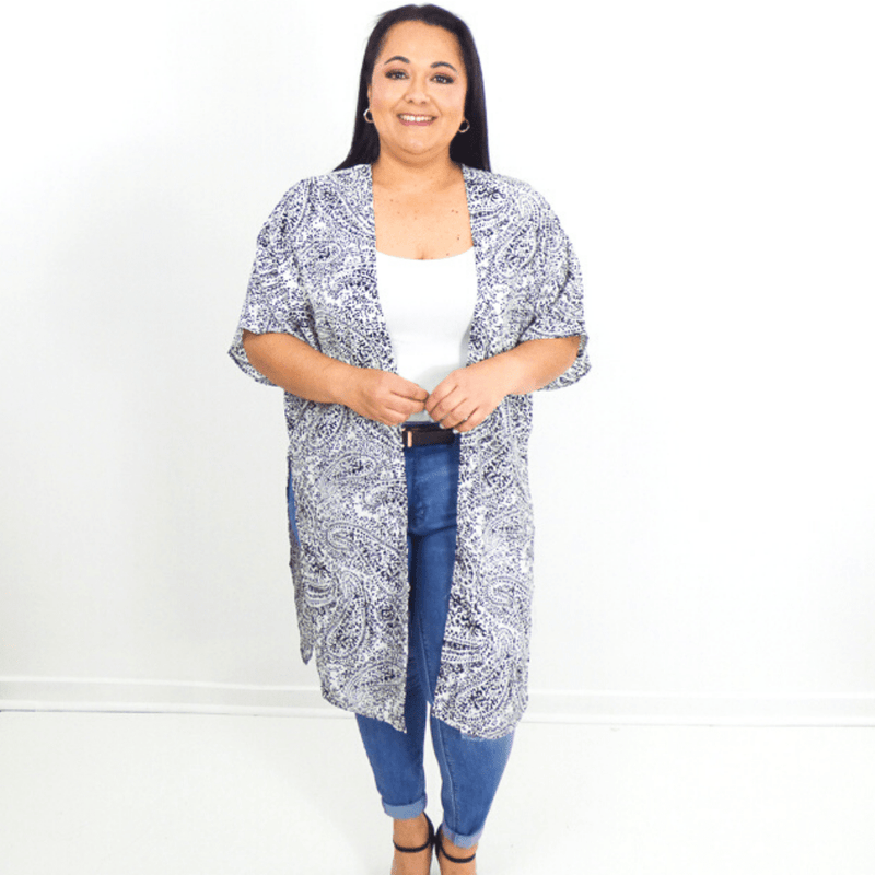 A fun kimono with a beautiful paisley print and an open front. This kimono lands on the knee and has half sleeves, making it perfect for layering over dress tanks or even swimsuits.