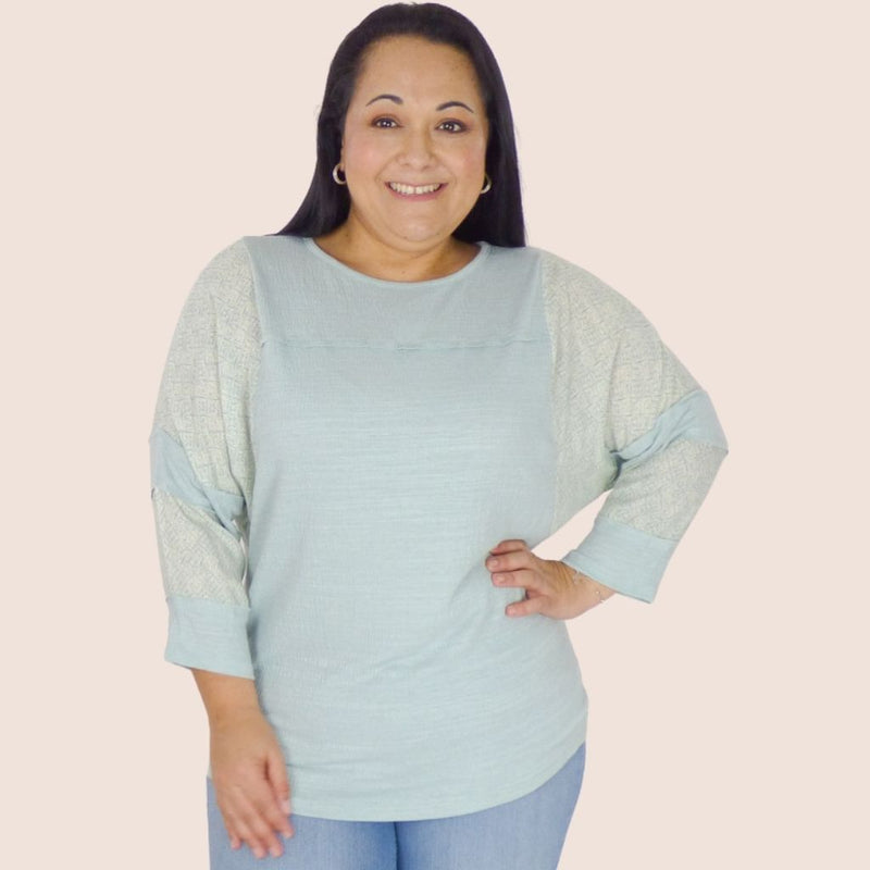 The Patchwork Sleeve Plus Size Knit Top is the perfect layer for milder temps. Its soft jersey fabric features stitch detail throughout, along with long batwing sleeves.