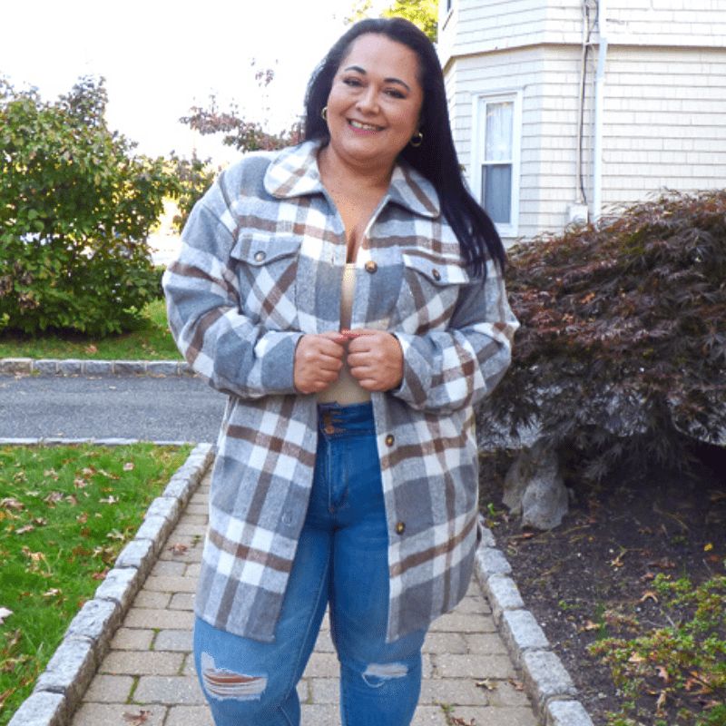 Get your hands on our new shacket! Our Tommy Plaid Tunic Shacket mixes charcoal, grey, camel, and ivory plaids. Features a collar, pockets, and front button closures.