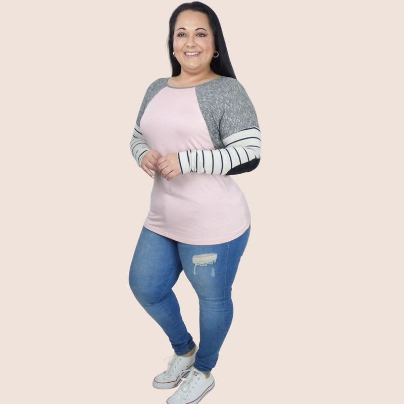 This solid plus size top features contrast striped details and raglan long sleeves with elbow patches. It's round neck creates a sleek and slimming look on any body type.