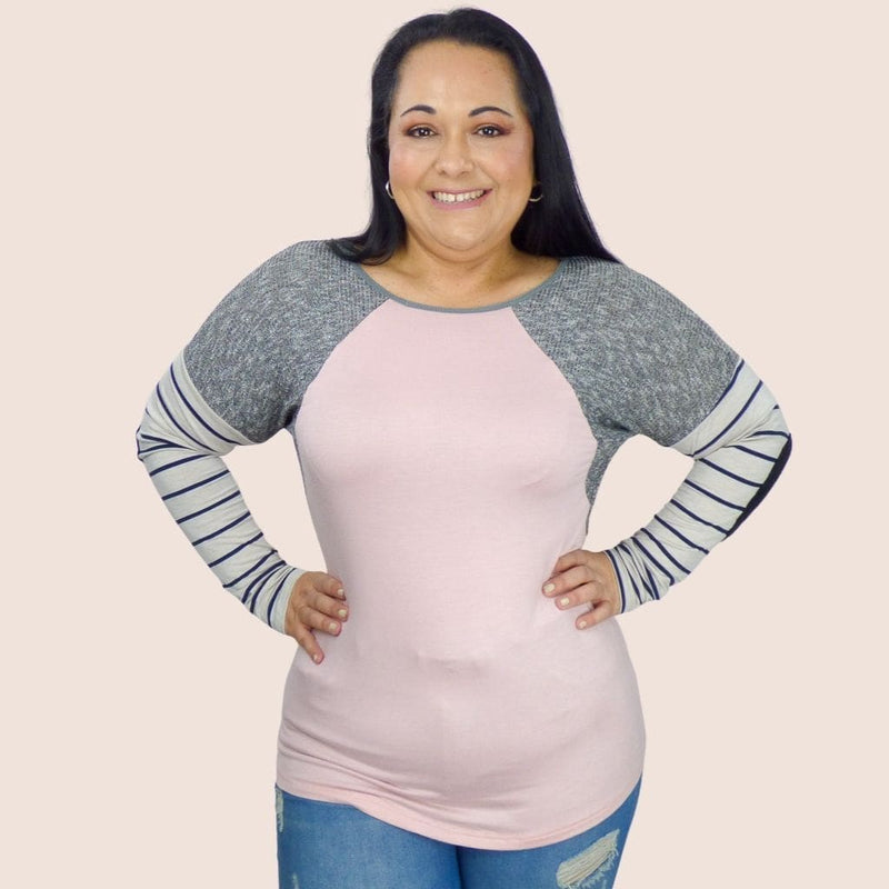 This solid plus size top features contrast striped details and raglan long sleeves with elbow patches. It's round neck creates a sleek and slimming look on any body type.
