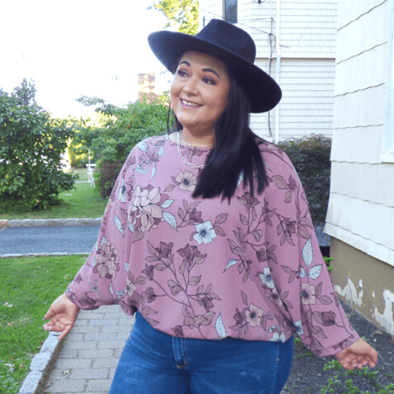 Arrive to your destination looking fabulous with this gorgeous plus size top featuring dolman style sleeves, and an elastic waist for that faux tucked in look!