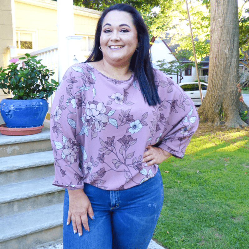 Arrive to your destination looking fabulous with this gorgeous plus size top featuring dolman style sleeves, and an elastic waist for that faux tucked in look!