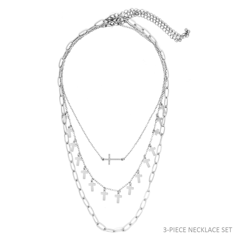 This Silver Cross Layered Three Piece Necklace will be the perfect addition to your collection. This set includes three layers with 15 crosses and a 16" chain that extends to 18".
