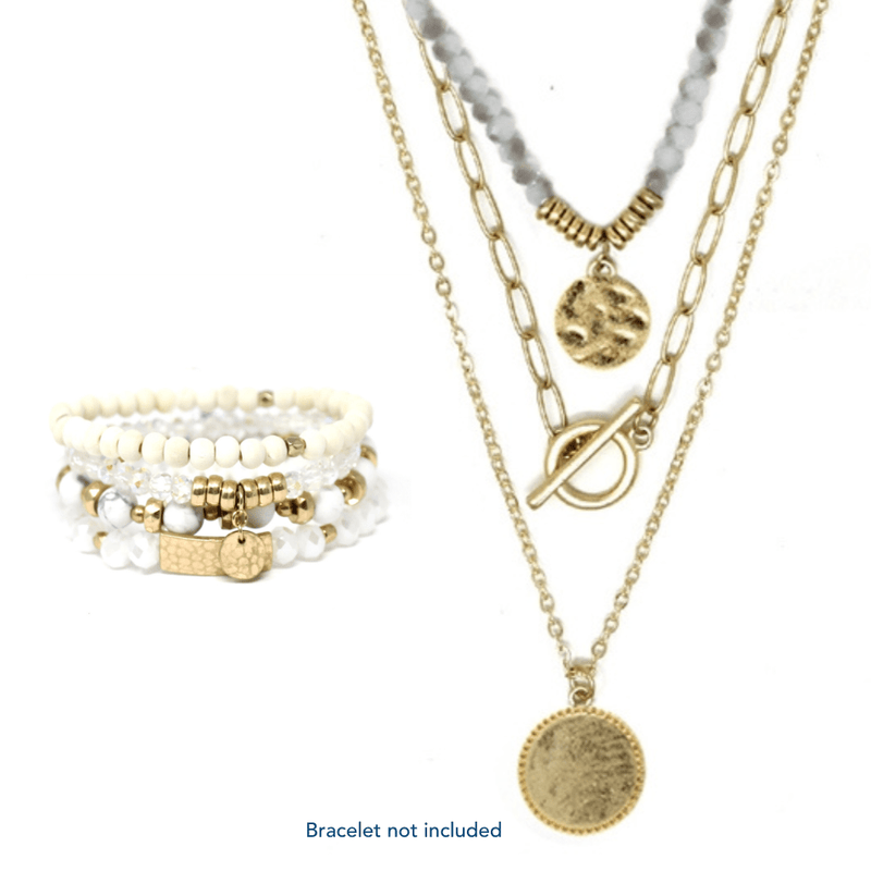 This triple-layered necklace is crafted using natural stones and gold accents. The white color and simplicity of the design make this a classic piece that can be worn with any outfit or on any occasion.